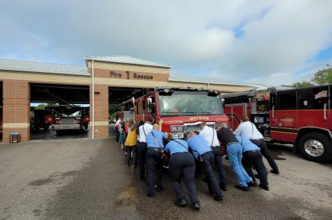 Firefighters at Oviedo Fire State #46 push Tower 46 into the station bay Friday during a traditional ceremony when a new fire engine is put into service. 