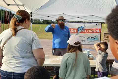 A Winter Springs employee teaches children about fishing and the environment during last weekend’s event.