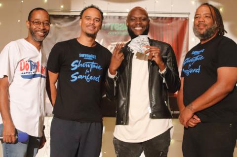 The first winner of the new Showtime in Sanford season was Ceion, holding money, who took home the $500 cash prize Thursday night. Here he poses with show host Jay Love, left, Surrealist Entertainment founder Lawrence Gordon, and Surrealist partner Kelvin Patterson.