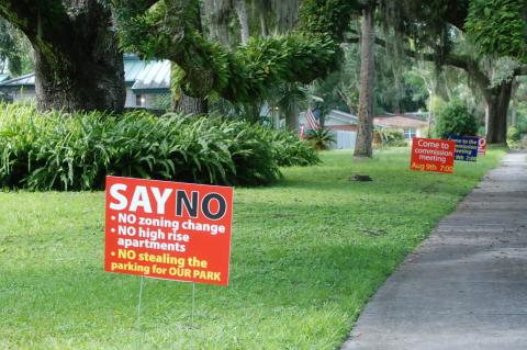 Residents put up signs throughout Sanford urging citizens to attend the commission meeting about the apartment complex.
