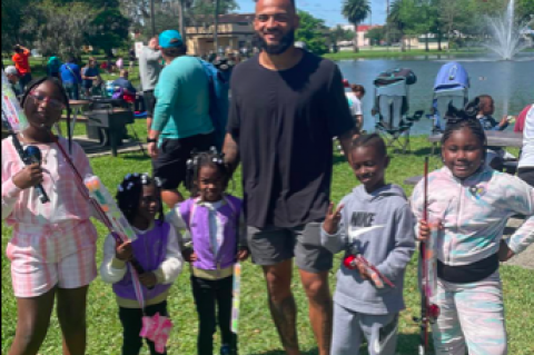 NFL Player Gabriel Davis (center) with kids at Sunday’s Kids Fishing Rodeo at Lake Carola in Fort Mellon Park.