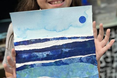 Brianna Kotsikas, 4th grader, displays her artwork at the Historic Sanford Welcome Center on Thursday.