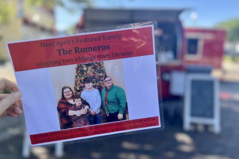 A sign at the Hao Bao Bao Coffee stand shows the Romero family, the featured family last month.