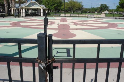 A lock on the gate of the Splashpad at Fort Mellon Park on a spring break afternoon shows how the coronavirus pandemic has affected life in Sanford.