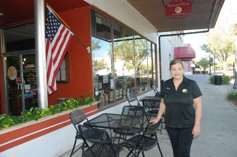 Colonial Room Owner Michelle Simoneaux (above) in front of the Colonial Room on 1st Street in downtown Sanford. 