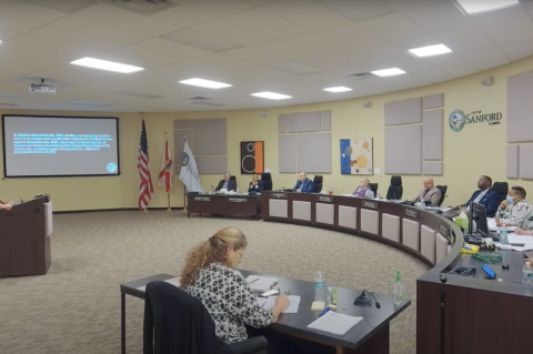 Sanford resident Leon Konieczny (left) speaks before the Sanford City Commission on Monday about the funding for the Heritage Park project, which was up for approval during the commission meeting. 