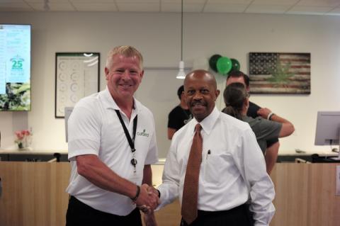 Curaleaf Sanford Dispensary Manager Shawn Porter with Norton Bonaparte, Sanford City Manager celebrating the grand opening of Sanford's first medical cannabis center.