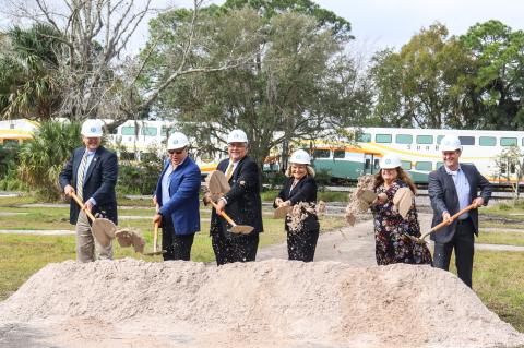 City of DeBary leaders (above) break ground on the new Main Street project as the SunRail train passes behind them.