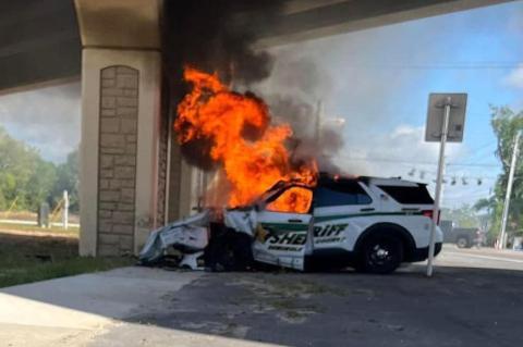Deputy Matthew Luxon was pulled from his vehicle (above) just moments before the flames engulfed the cab of the vehicle.