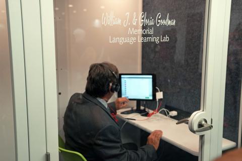 Commissioner Lee Constantine tries out the language learning lab.