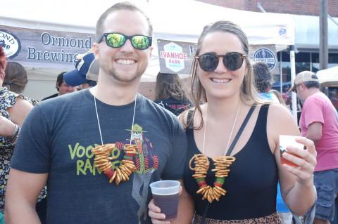 Nick Miller, 28, and Amber Smith, 27, don homemade beer and gummy necklaces made especially for the Bad at Business Beerfest held Saturday in Sanford.