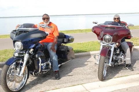 Reggie Mickins, left, of Tifton, Georgia, and Charles Colebrook of West Palm Beach enjoy the picture-perfect weather along Lake Monroe at the Bokey Riders Picnic in Fort Mellon Park Friday afternoon.