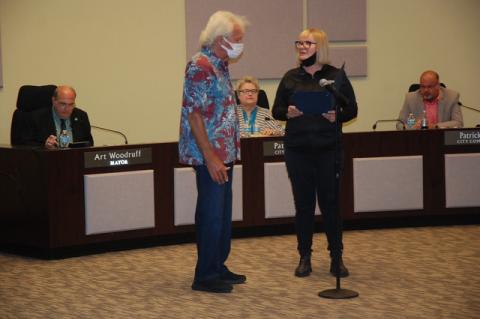 City Arborist Elizabeth Harkey, right, presents a certificate of recognition to Larry Blair for a donation of 15 oak trees to the City of Sanford.