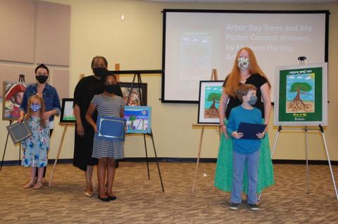 All three winners of the Arbor Day poster contest and their moms, Aurelia Oldeack, 5, left; D’Nia Montgomery, 9, center; and August Babcock, 9.