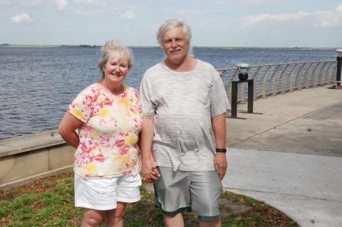 Teresa and Gary Girard of DeLeon Springs walk hand in hand along the RiverWalk Wednesday.