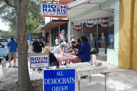 Supporters gather outside of the Biden-Harris headquarters in downtown Sanford. 