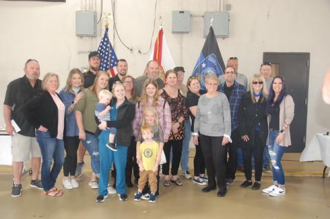 Officer Mike Bernosky (center) with his family during his retirement ceremony Friday, Feb. 11, 2022.