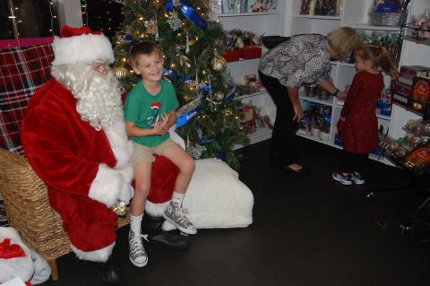 Santa talks over what one young boy wants for Christmas while they sit in the Peterbrooke Chocolatier store at 1145 Town Park Ave., in Lake Mary. 
