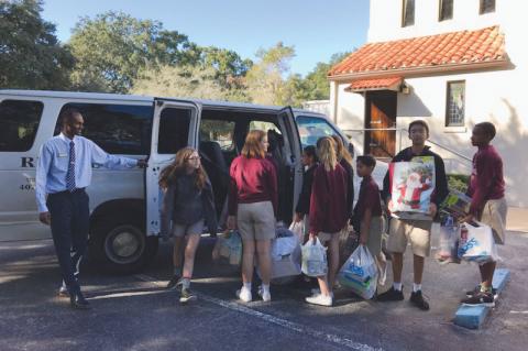 Students at All Souls help to load toys into a van for Rescue Outreach Mission. 