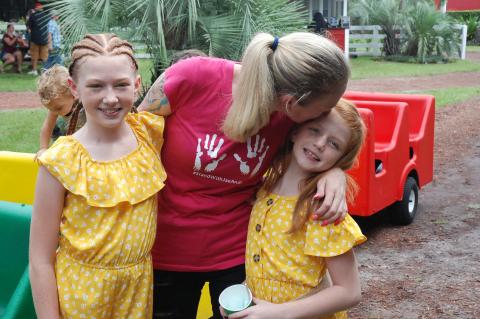 Mom Tabetha Ehlert (center) with her daughters Jaelyn and Jaleah during this weekend’s fundraiser.