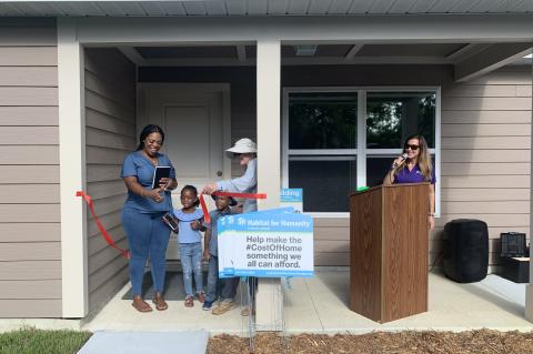 Catorreia Hutto (left) with her twins Ava and Ahmad Jackson during the ribbon cutting ceremony for their Habitat for Humanity home in July 2022.