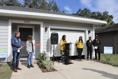 Wharton Smith, Inc. President Tim Smith (left), Habitat for Humanity Seminole-Apopka CEO Penny Seater and Latarshia Dixon and family (right) during Friday’s dedication service.