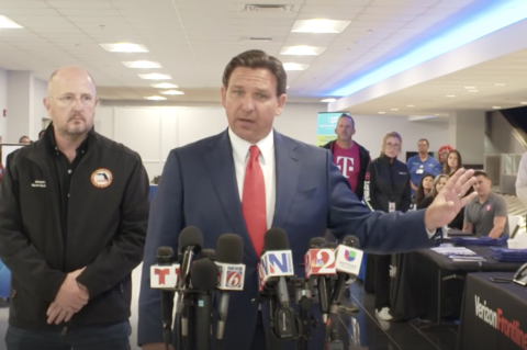 Florida Division of Emergency Management (FDEM) Director Kevin Guthrie (left) stands behind Florida Governor Ron DeSantis (center) during a press conference at Orlando Sanford International Aiport about the return of Floridians from Haiti on Wednesday. 