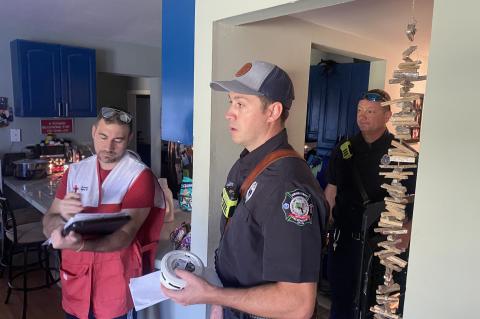 Seminole County Lieutenant J. Divita (center) with other members of the fire department and Red Cross during the smoke alarm blitz.