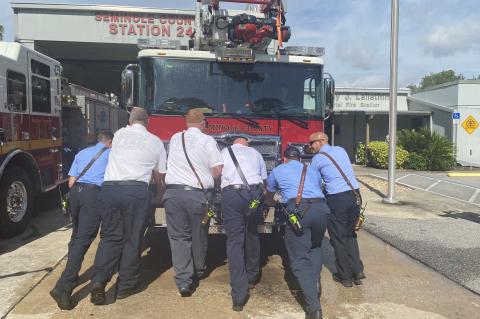 Members of the Seminole County Fire Department push Quint 24 into the service bay in Winter Springs to signal that the unit is ready to serve the community.