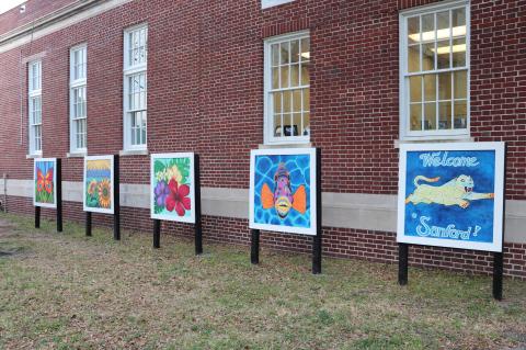 Colorful, new murals (above) painted by the City of Sanford’s Public Art Commission are displayed by the Sanford Information Center as part of the new Artisan Square on Thursday. 