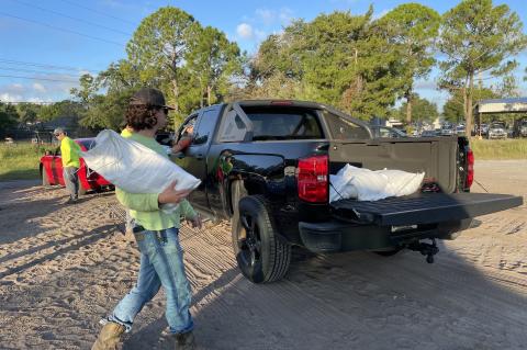 City of Oviedo crews help load sand bags into residents’ vehicles Monday as they prepared for Idalia. 