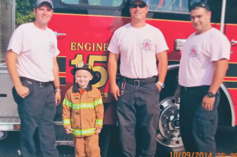Jacob as young boy meeting the crew from Longwood Fire Station 15 after they save his life. 