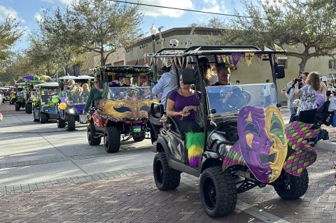 Participants at the Mardi Gras drive their decorated golf carts during the Mardi Gras sashay on Saturday.
