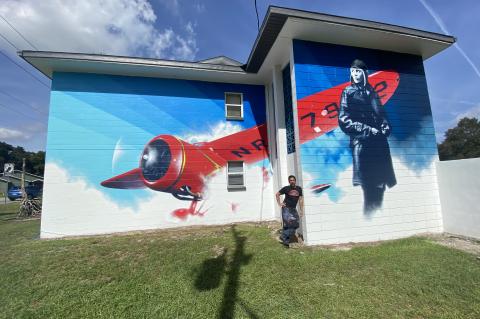Orlando Artist Jaime Margary in front of his mural that honors pilot Amelia Earhart at 900 E. Airport Blvd.