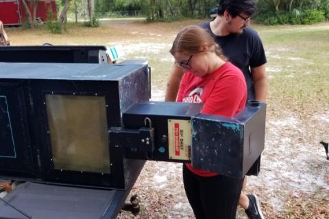 Angeley and Chase Ford work to modify newspaper boxes into Free Little Pantries.