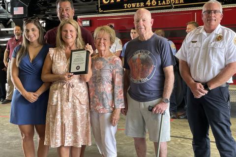 Teacher Suzanne Matos with her family (left) and Oviedo Fire Chief Michael Woodward (right).