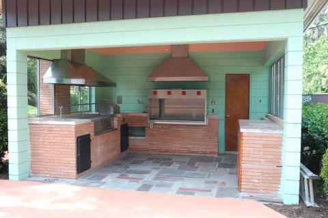The outdoor patio area includes an area for grilling and entertaining and includes a pool and male and female dressing rooms. 