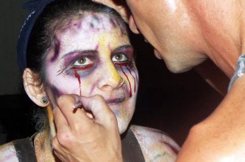 Employees of the Petrified Forest put on their makeup and costumes to scare guests at the Halloween attraction. 