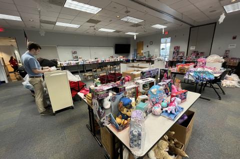 Members from Seminole County Public Schools and social workers organize donated toys for the Giving Tree.