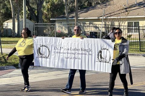 Dr. Martin Luther King, Jr. Celebration Steering Committee Chairman Melvin Philpot (center) walks with other committee members during Monday’s parade.