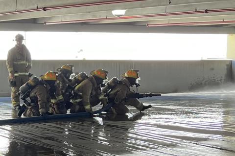 Firefighter recruits practice managing the fire hose during a training session at parking garage at the Altamonte Springs mall last week. 