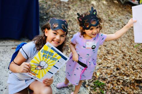 Kids with a free book (above) from the New Worlds Reading Initiative celebratory event at the Central Florida Zoo. 