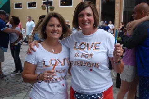 Tracey Burns (left) and Michelle Campbell hold their symbolic popcicle sticks during the vigil. 