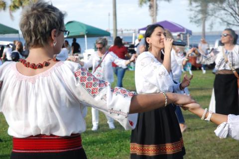Silvia Iancu of Jacksonville sings for the dancers at the Romanian Traditions Festival Dec. 1 in Fort Mellon Park.