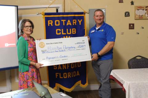  Kay Boehart with Hamilton Elementary School received a grant for $1,200 toward food programs from the Sanford Rotary Club on Monday, presented by member Tim Tolbert.