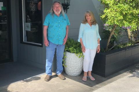 Sanford Flower Shop Owners Tim Donahoe (left) and Kit Whigham in front of Sanford Flower Shop on Commercial Street in downtown.