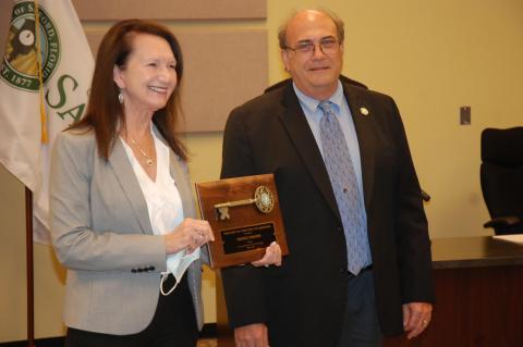 Former Airport Authority CEO Diane Crews (left) holds her Key to the City with Mayor Art Woodruff. 