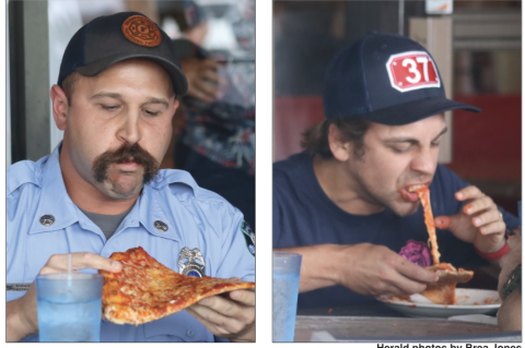 The Seminole County Fire Department (left) faced the Lake Mary Fire Department (right) during the pizza-eating contest held Tuesday. The Lake Mary team of firefighters was the overall winner of the contests that day.