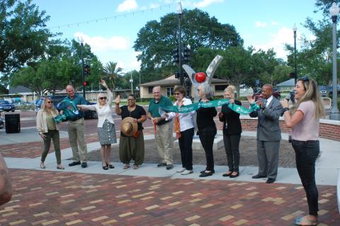 Members of the Public Art Commission and the Sanford City Commission cut the ribbon for the Sanford Sculpture Walk, which spans the RiverWalk to Paulucci Park at 1st Street and Sanford Avenue. 