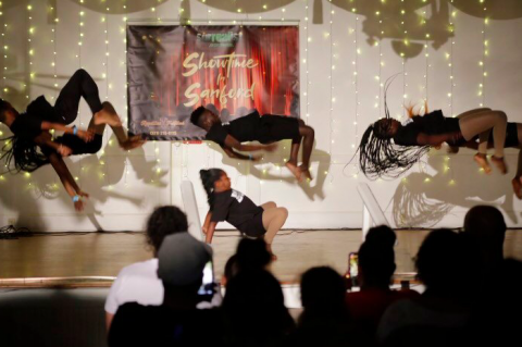 The Prissy Dance Troupe of Sanford appears to hover over the stage at the Sanford Woman’s Club Thursday night as they compete in the season finale of Showtime In Sanford.